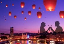 Top Rooftop Bars in Lyon with Stunning City Views Lyon cityscape at dusk with cocktail and lanterns.