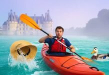 Loire Kayaking Guide: What to Expect on the River A man kayaks nervously down a river, losing his hat, with a chateau in the background.